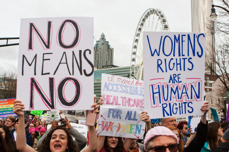 Women hold up signs in support of women’s rights, as thousands of protesters participate in the March For Women on January 21, 2016 in Atlanta, GA.