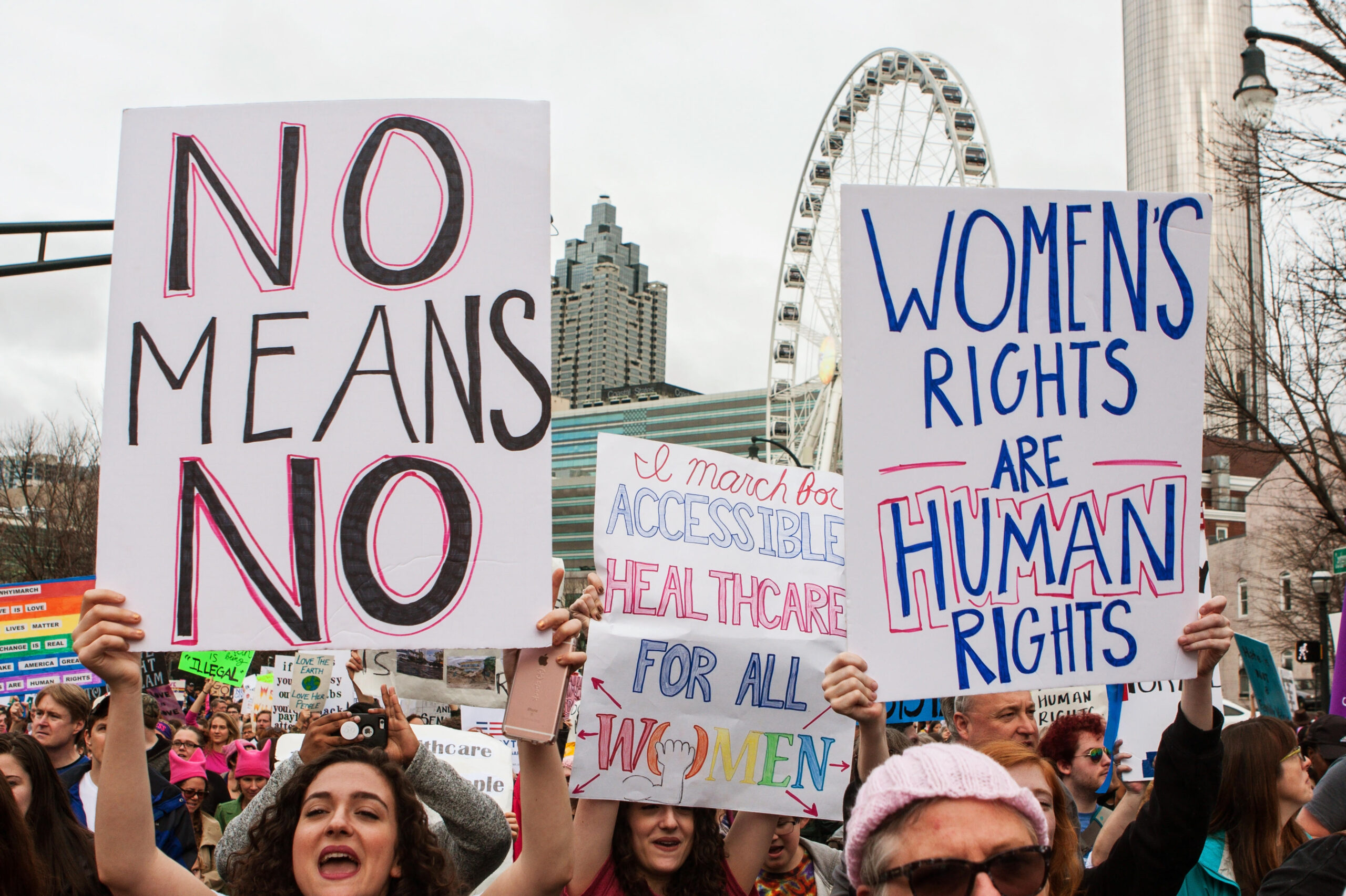 Women hold up signs in support of women’s rights, as thousands of protesters participate in the March For Women on January 21, 2016 in Atlanta, GA.